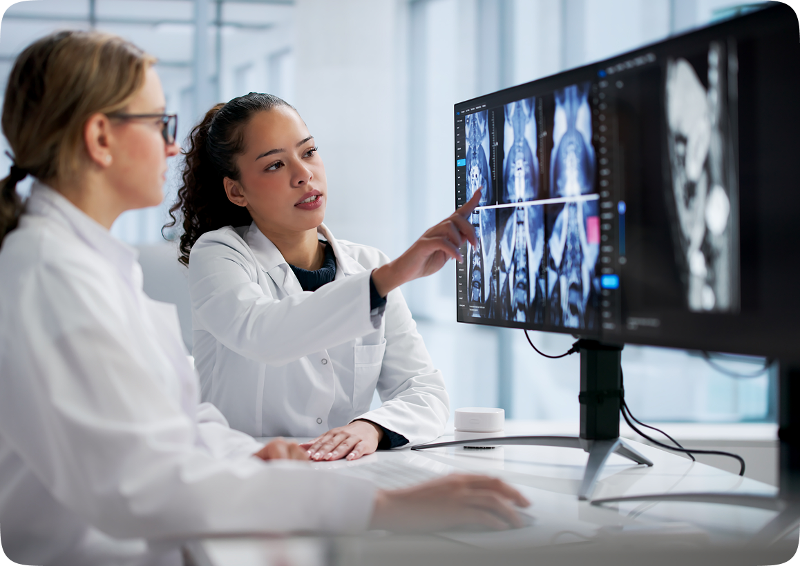 Scientists analyzing medical scans on computer screens.